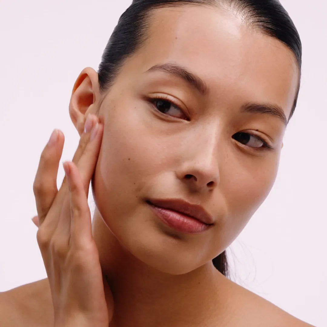 Serum being massaged across the face and neck