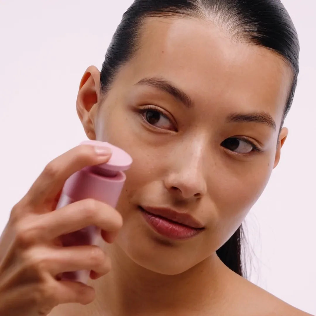 Serum being massaged across the face and neck