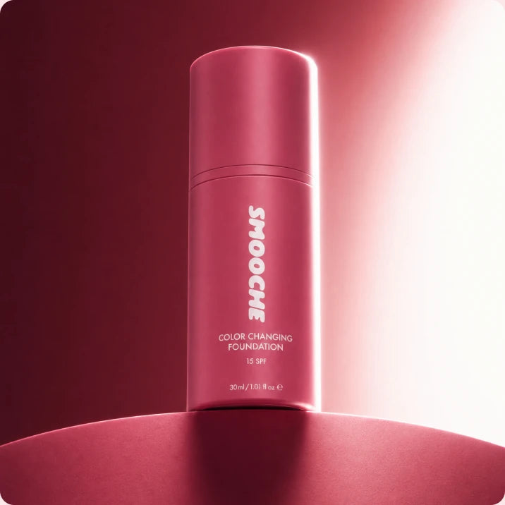 Smooche Color Changing Foundation bottle on a deep red backdrop