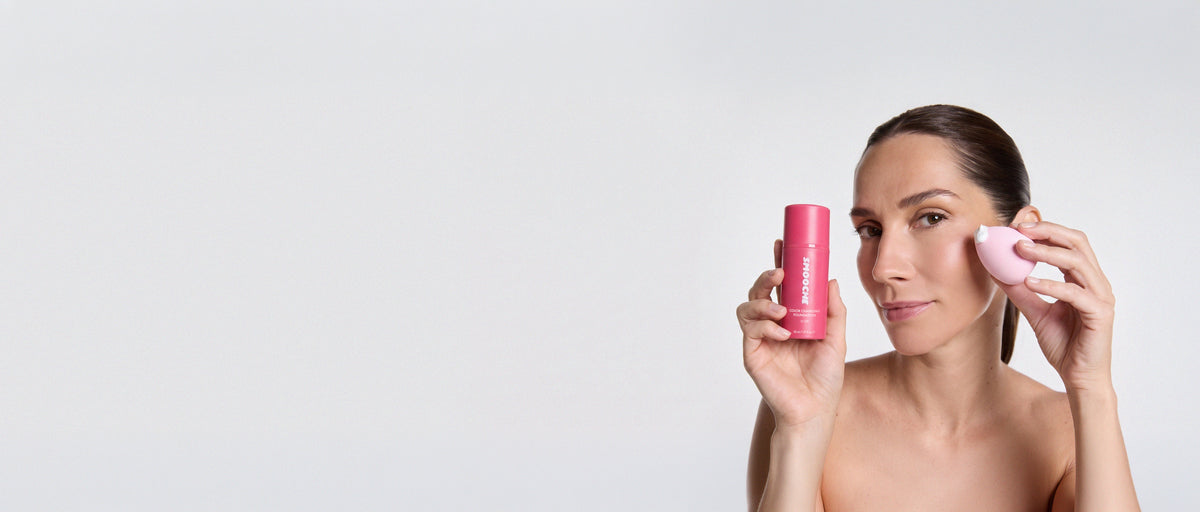 Woman applying Smooche Color Changing Foundation