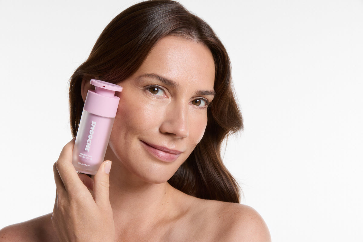Woman holding Smooche Reverse-Time Peptide Serum