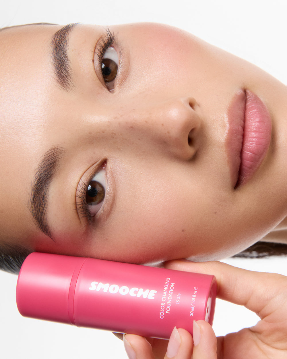 Woman holding the color changing foundation